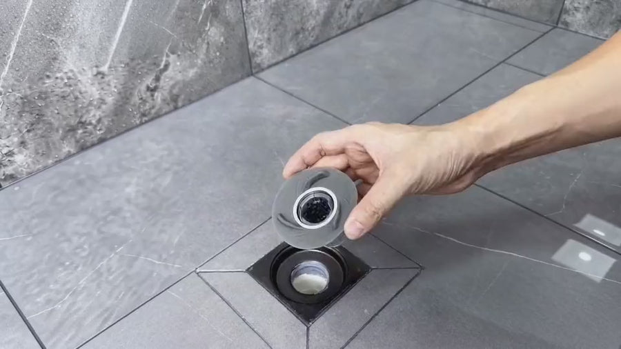 MagClean catches shower hair, then the magnetic collector lifts out and opens so the hair can slide away without finger contact.
